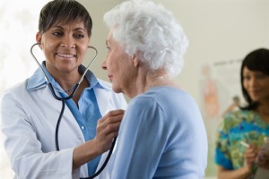 Photo of elderly woman being examined by doctor