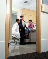 Father and daugher in physician's office