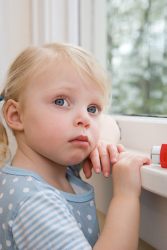 Child looking out of a window