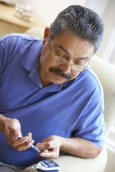 Man checking blood glucose