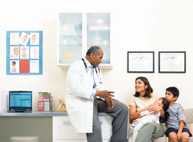 Physician speaking to mother with children