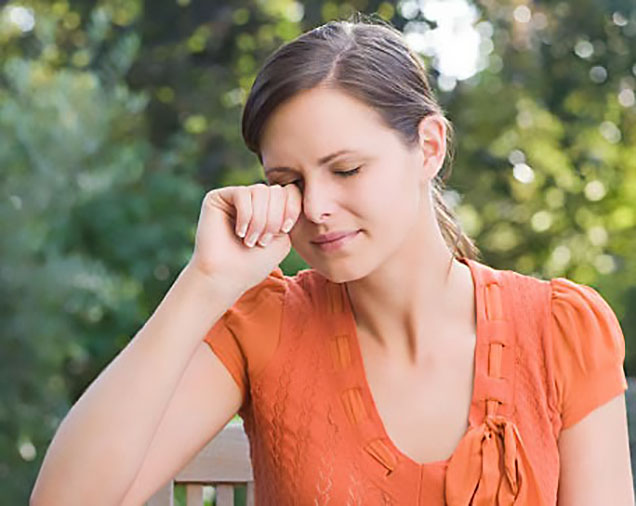 Woman rubbing her eyes