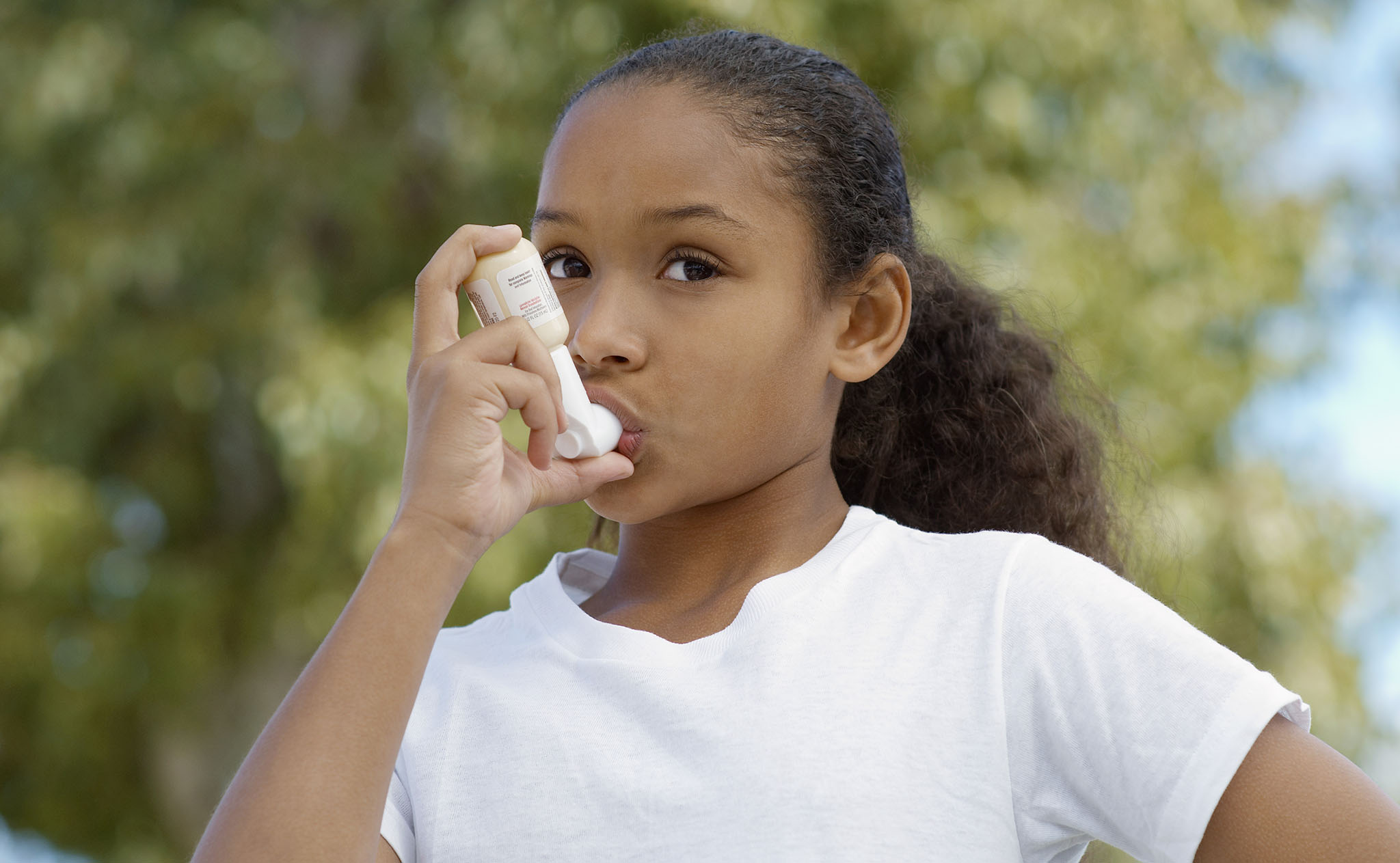 Child using asthma inhaler