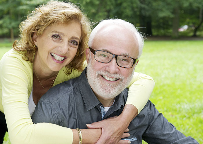 Happy older couple smiling and showing affection