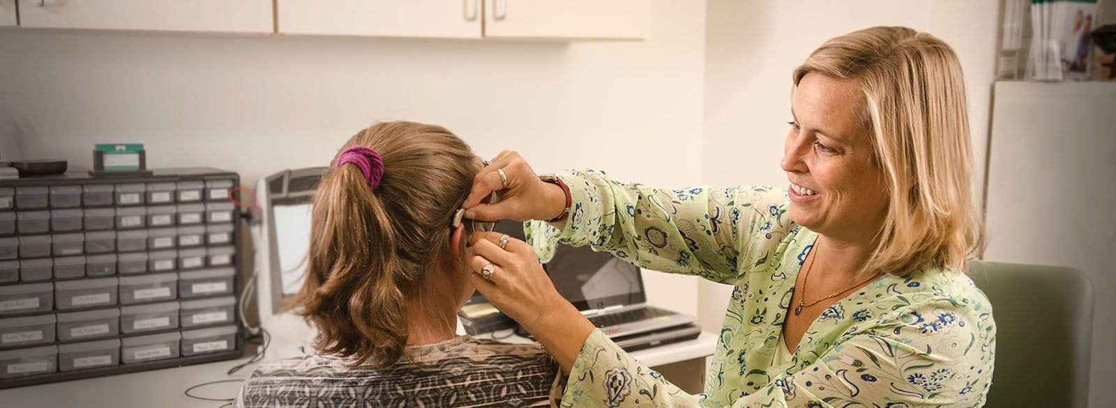 Patient being fitted for a hearing aid by audiologist Laura Burger