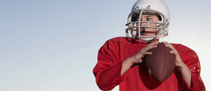 Young child in football uniform