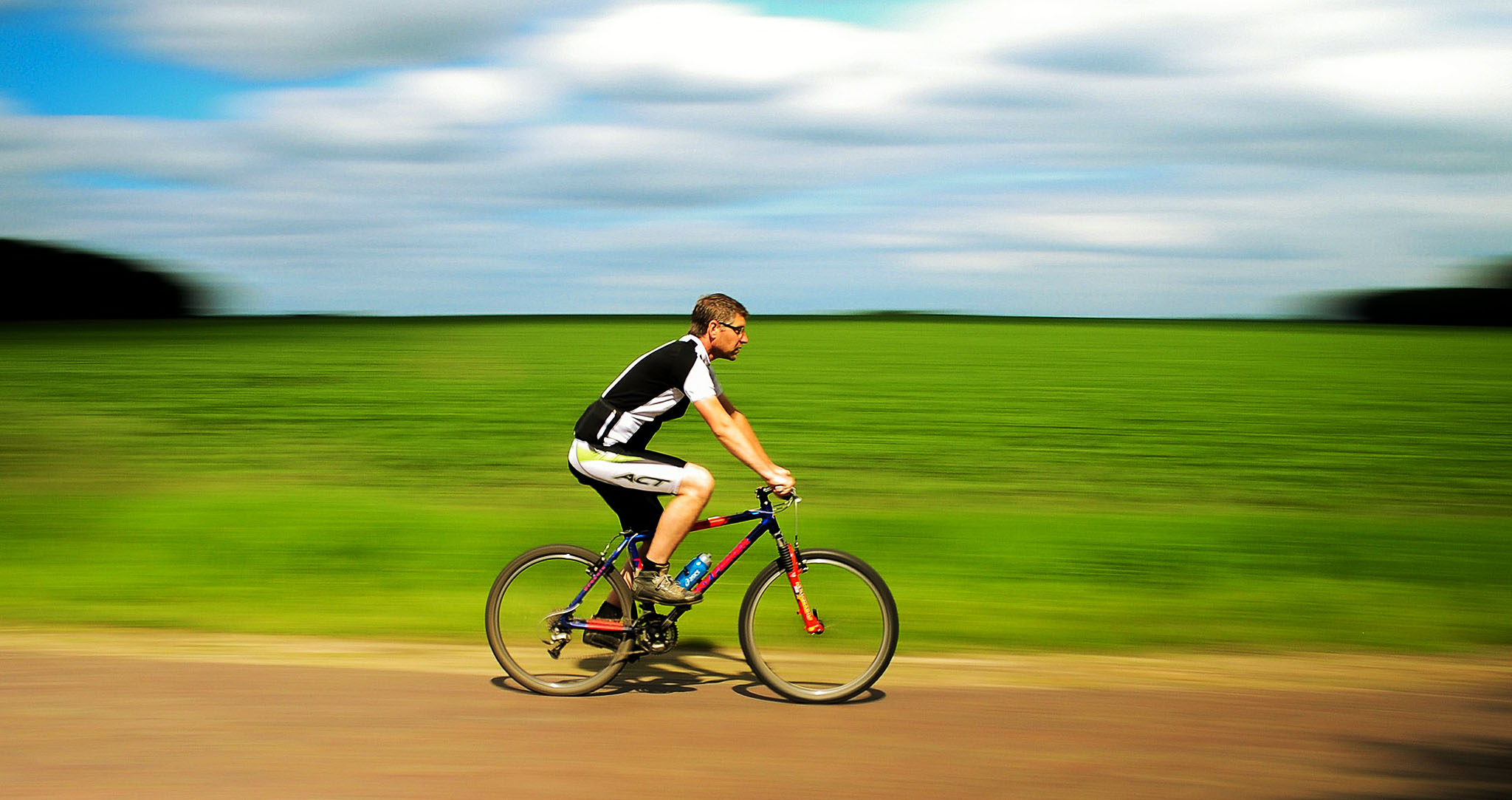 Man riding bike through countryside