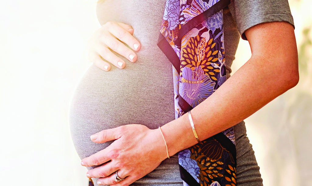 pregnant woman with hands on her belly