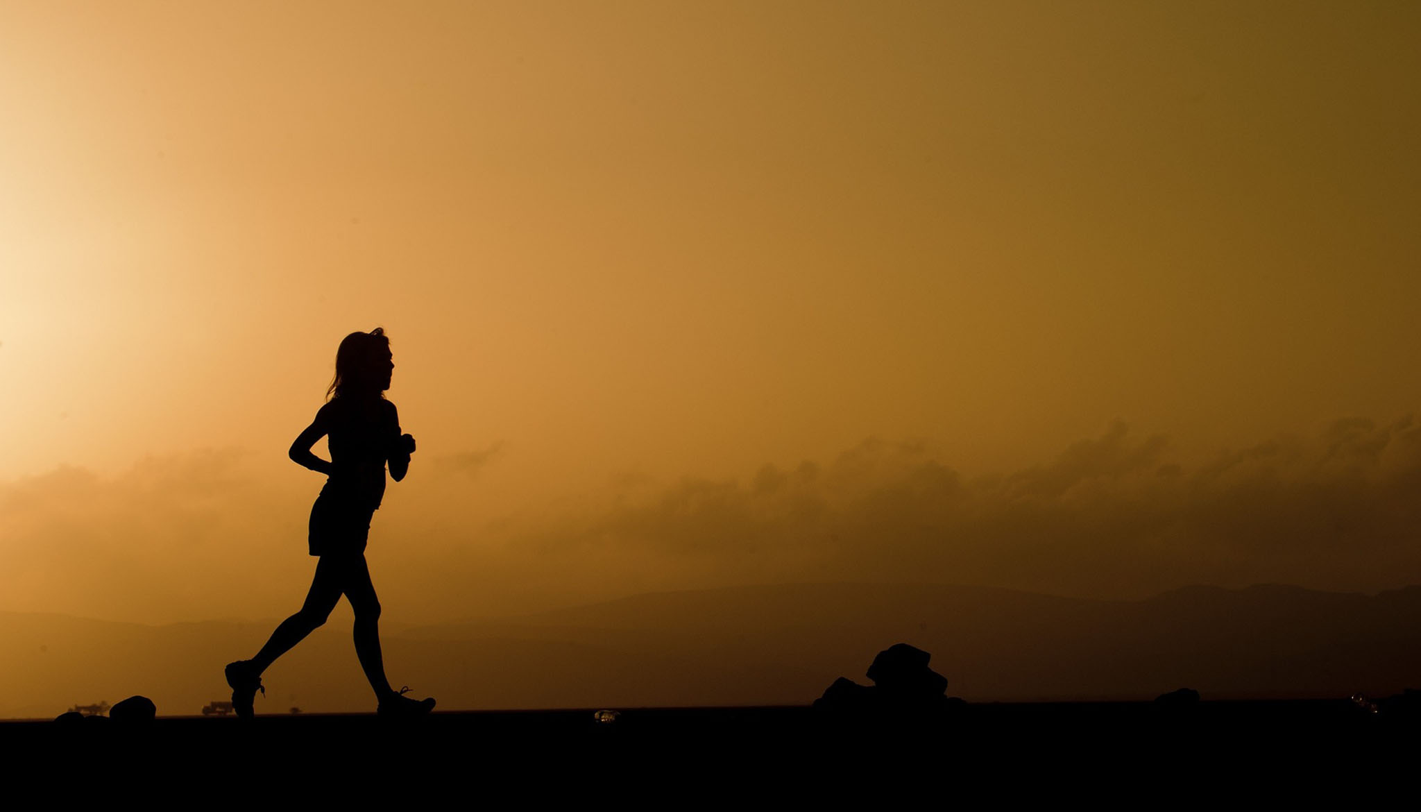Silhouette of female distance runner