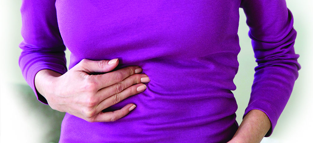 Woman with GERD holding abdomen