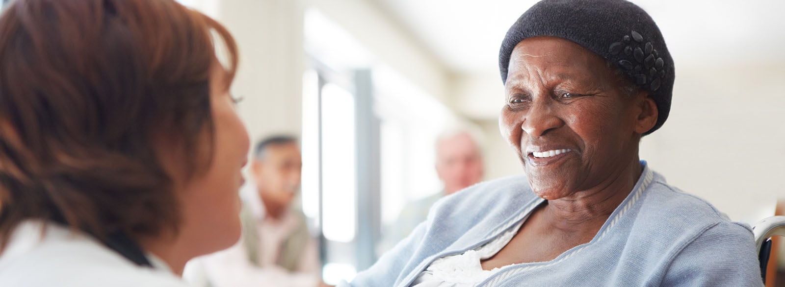 Provider speaking with elderly female patient