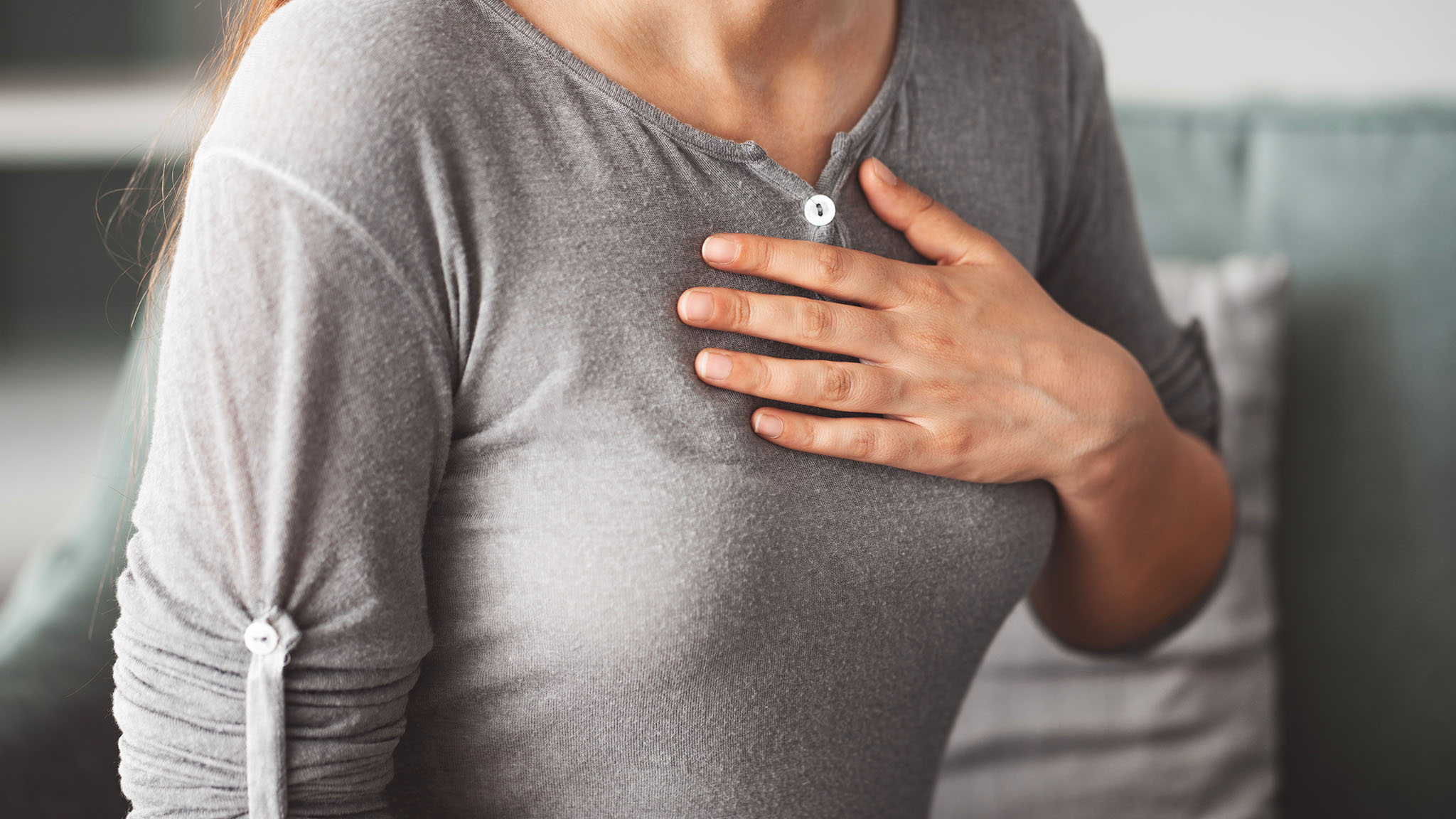 Women with hand on her chest.