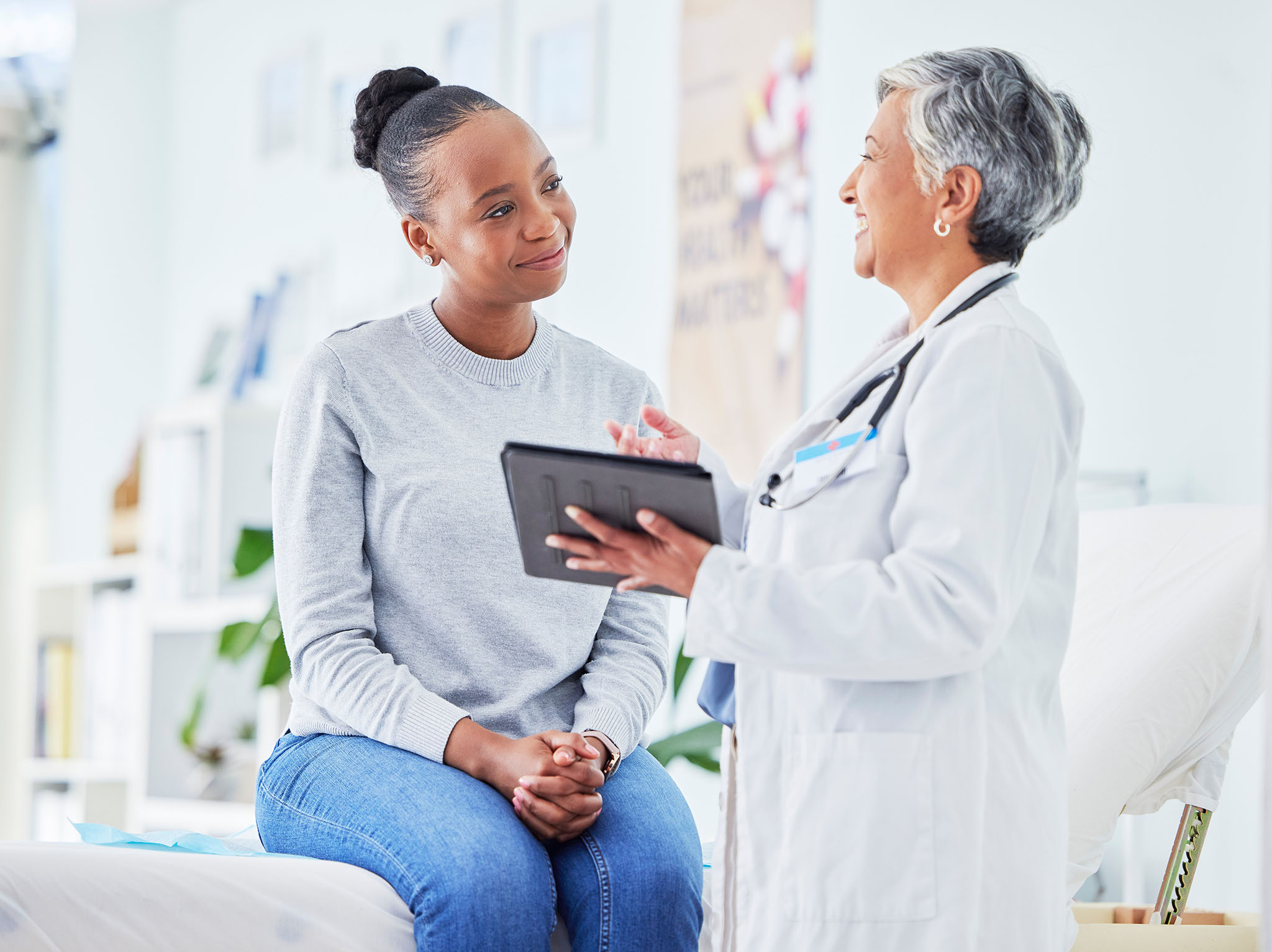 African American woman talking with her female physician.