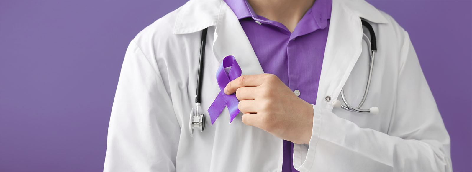 Doctor with blue ribbon on color background, closeup.