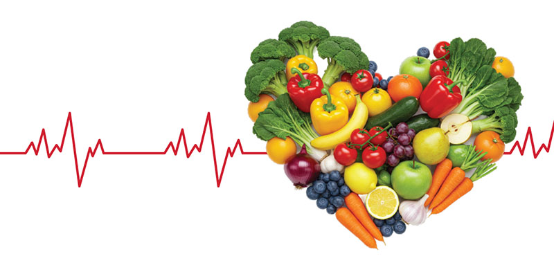 Vegetables and fruits arranged in the shape of a heart.
