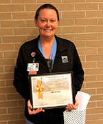 Carri Wheeler, RN, holding certificate and gift bag.