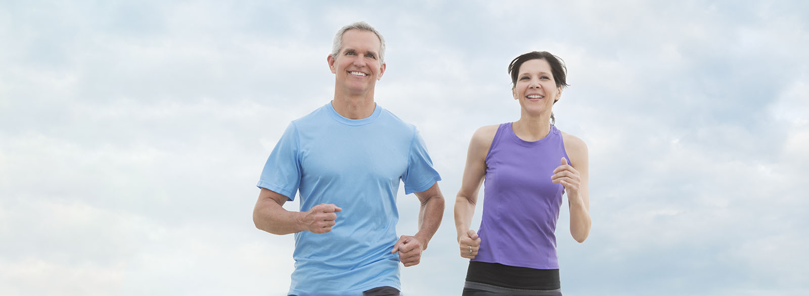 Middle aged couple jogging.