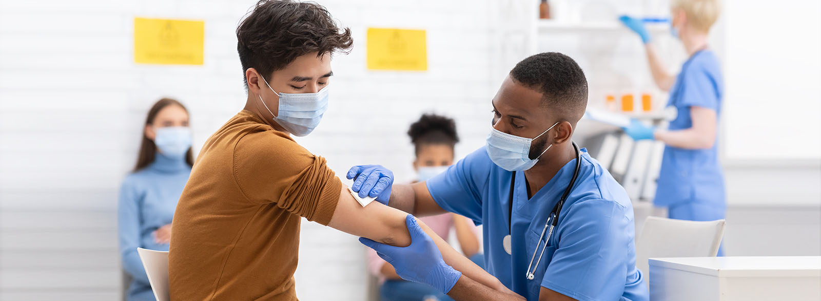 Provider prepping a patient for a COVID vaccine.