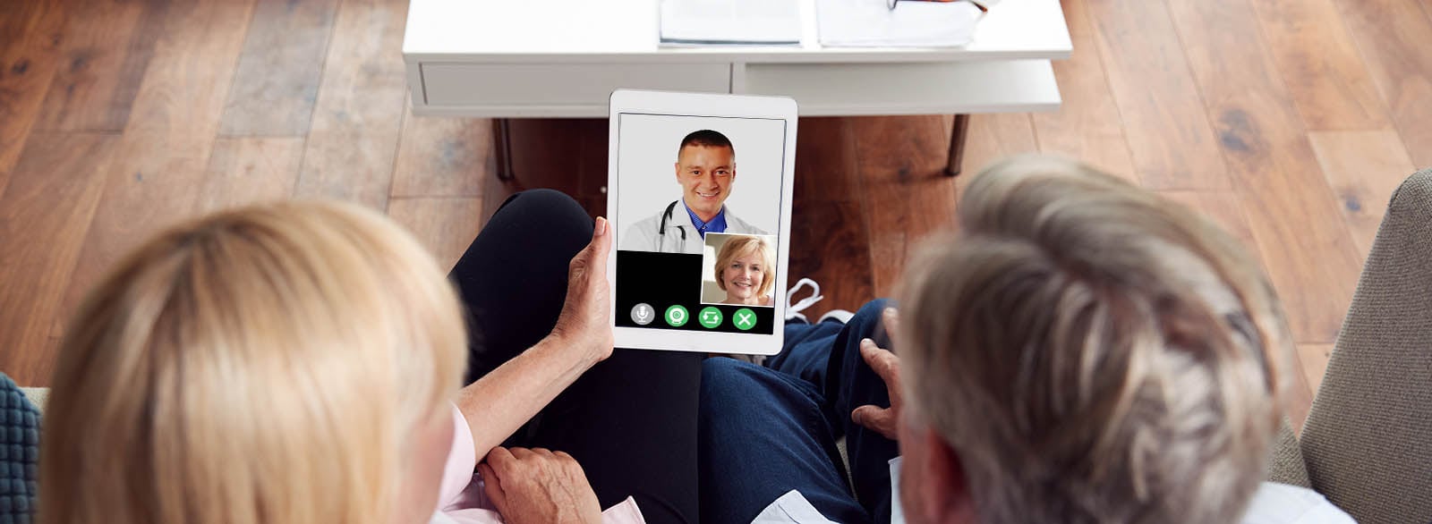 Older couple in video visit with a physician.