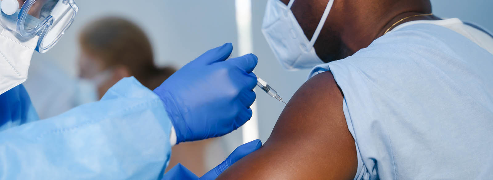 Healthcare worker receiving the COVID-19 vaccine.