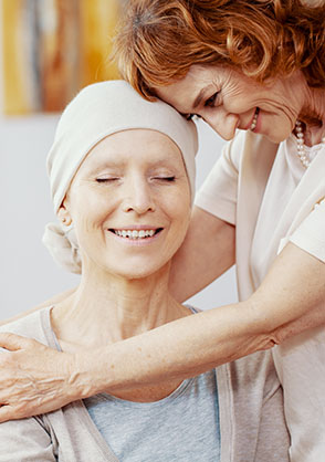 Caregiver hugging a patient.
